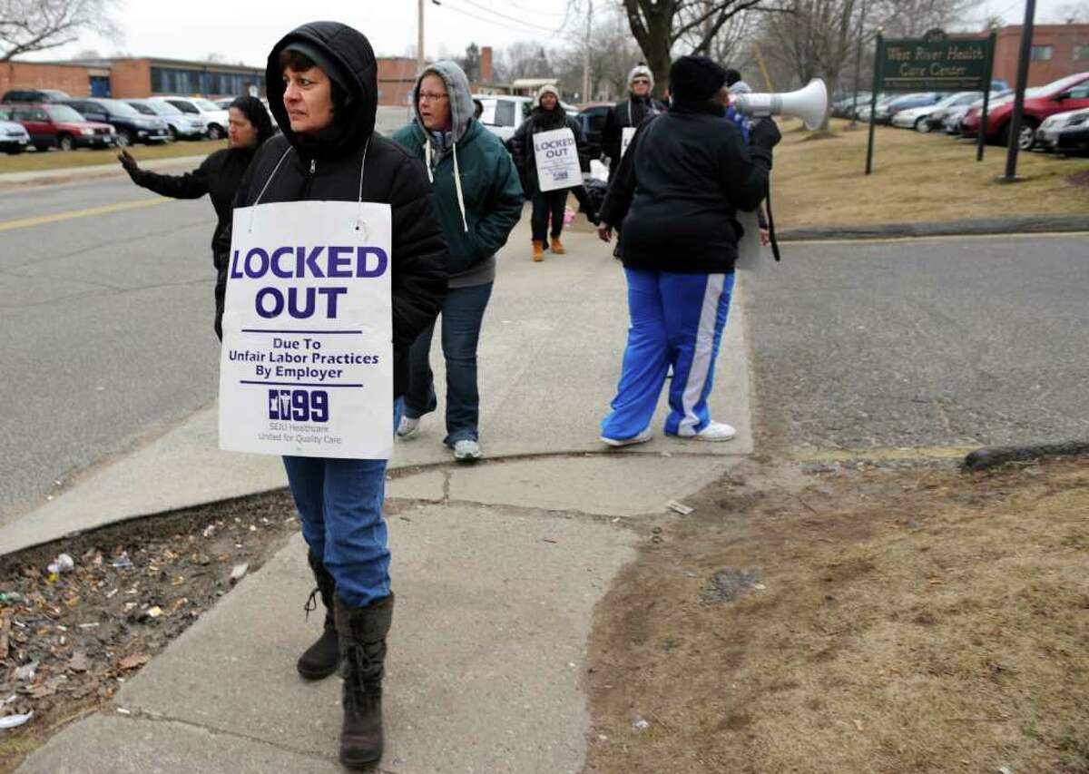 Debbie Wolfe, of Milford, walks the picket line Thursday, Feb. 16, 2012 in front of West River Health Care Center in Milford, Conn., where she has worked for 18 years. Union members have been locked out of their jobs since mid-December. Affiliated Health Care Centers is threatening to close five nursing homes in the state because of longstanding labor negotiations with New England Health Care Employees Union, District 1199.