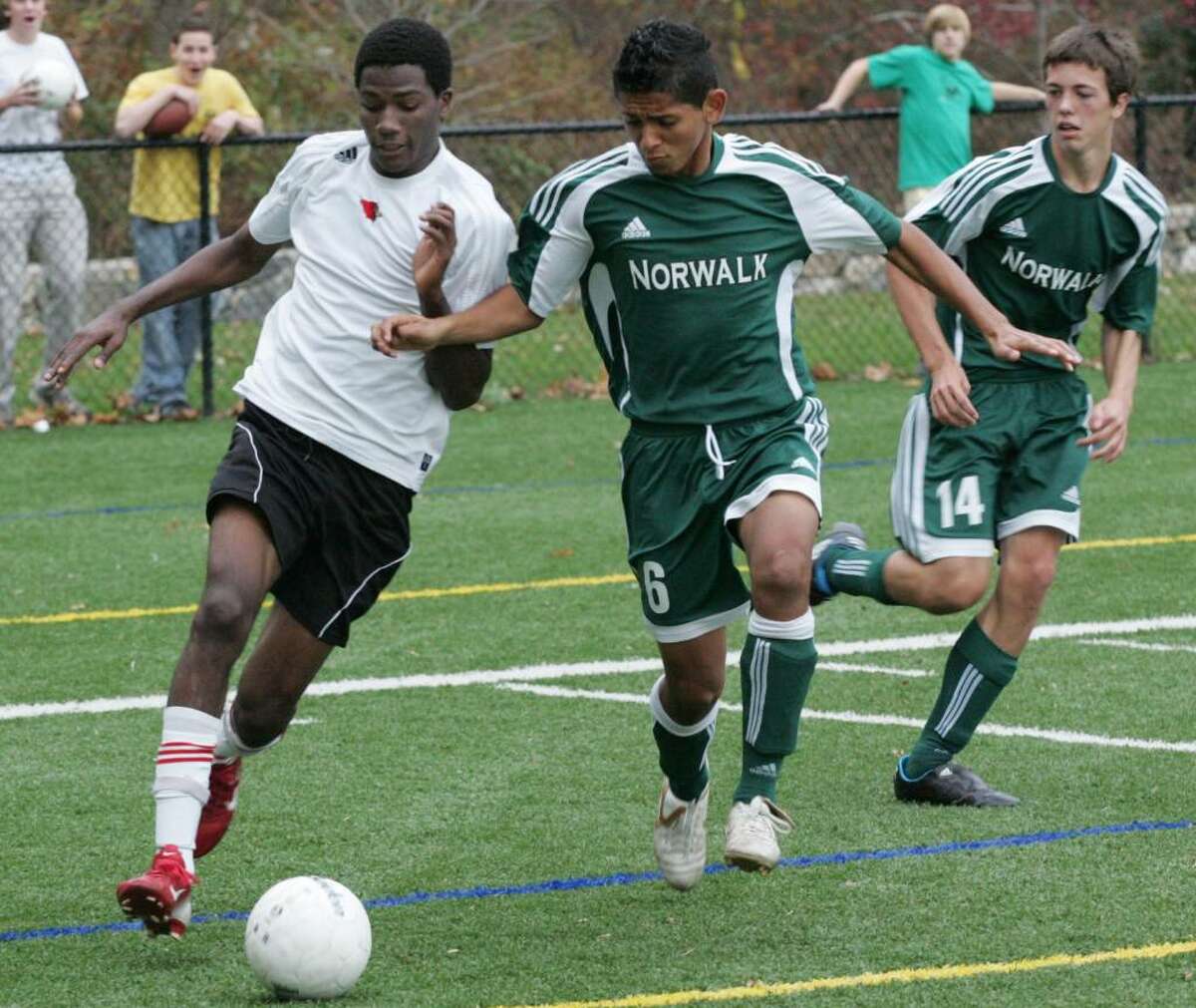 Greenwich High School striker Kenny Doublette makes his way toward the goal as Norwalk defenders Erick Romero and Chris Jeffrey put on the pressure. Mr. Doublette scored the only goal in the Cardinal's win over Norwalk.