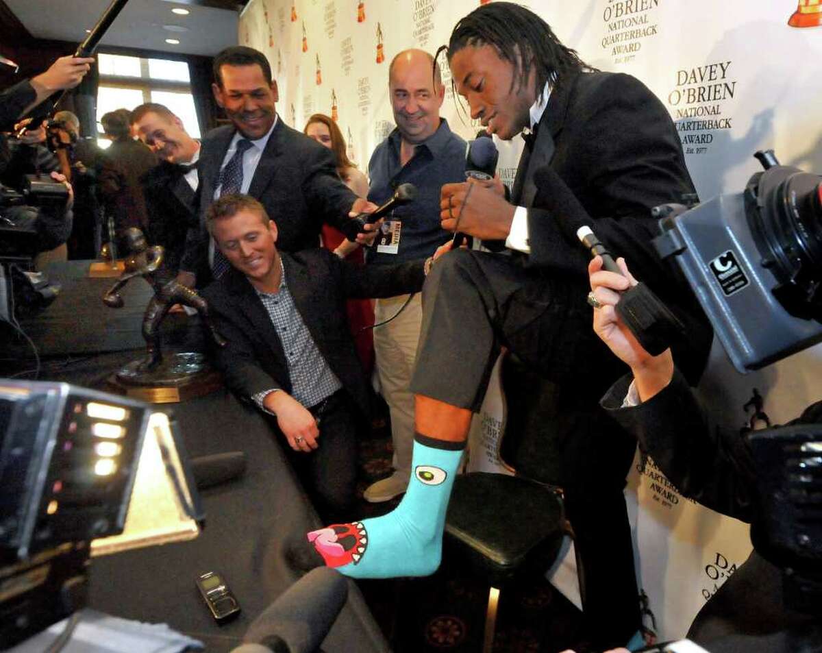 Former Baylor quarterback Robert Griffin III shows off his monster socks during a news conference in Fort Worth, Texas, Monday, Feb. 20, 2012, at the Davey O'Brien Award dinner. (AP Photo/Forth Worth Star-Telegram, Max Faulkner) MAGS OUT