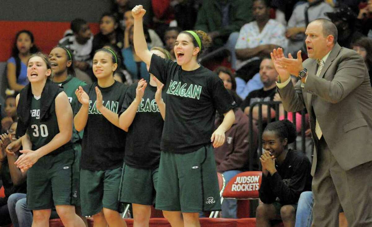 The Reagan bench cheers during a girls' high school basketball playoff game against Steele, Tuesday, Feb. 21, 2012, at Judson High School in Converse, Texas.