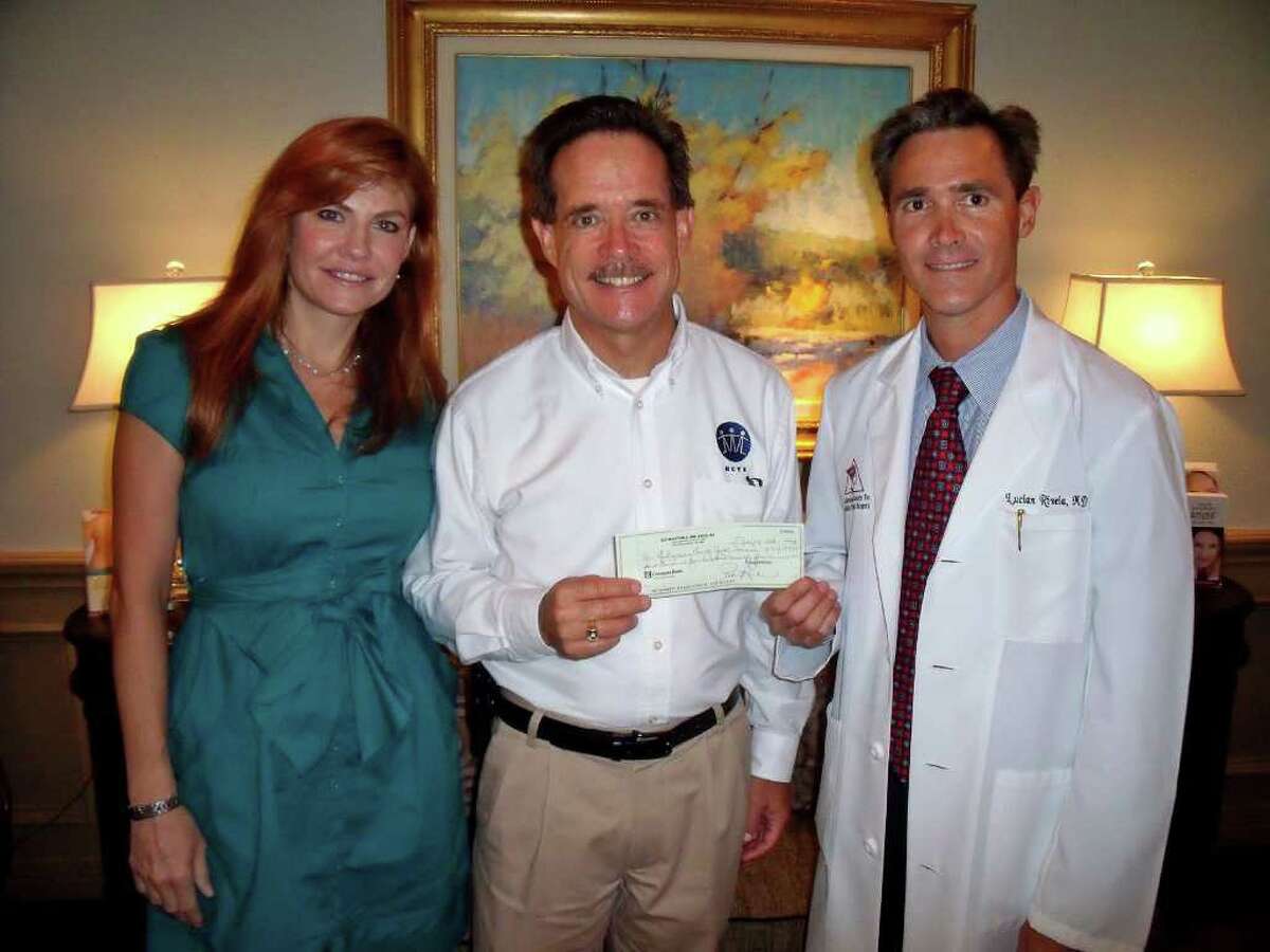 Rivela Plastic Surgery raised more than $1,700 for Montgomery County Youth Services (MCYS) through a raffle held at their recent CoolSculpting Open House in The Woodlands. Pictured are Patti and Lucian Rivela of Rivela Plastic Surgery as they present John