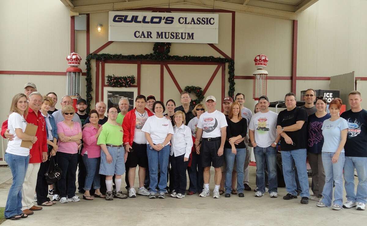 Pictured is Dana Pritchard, president of The Woodlands Car Club, (far left) standing with car enthusiasts along with Tony Gullo, Sr. (second to the left) who hosted the private tour in celebration of the car club's 10th anniversary.