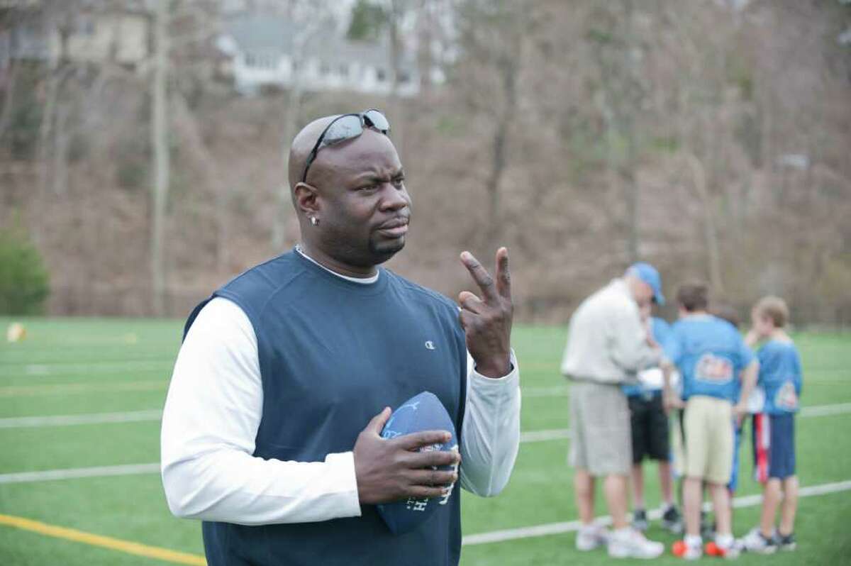 Greenwich Police Officer Donnell "Dee" Fludd coaches players in the Greenwich Flag Football League April 10, 2011, at Greenwich High School. Fludd has been placed on leave amid charges of stalking and harassment.