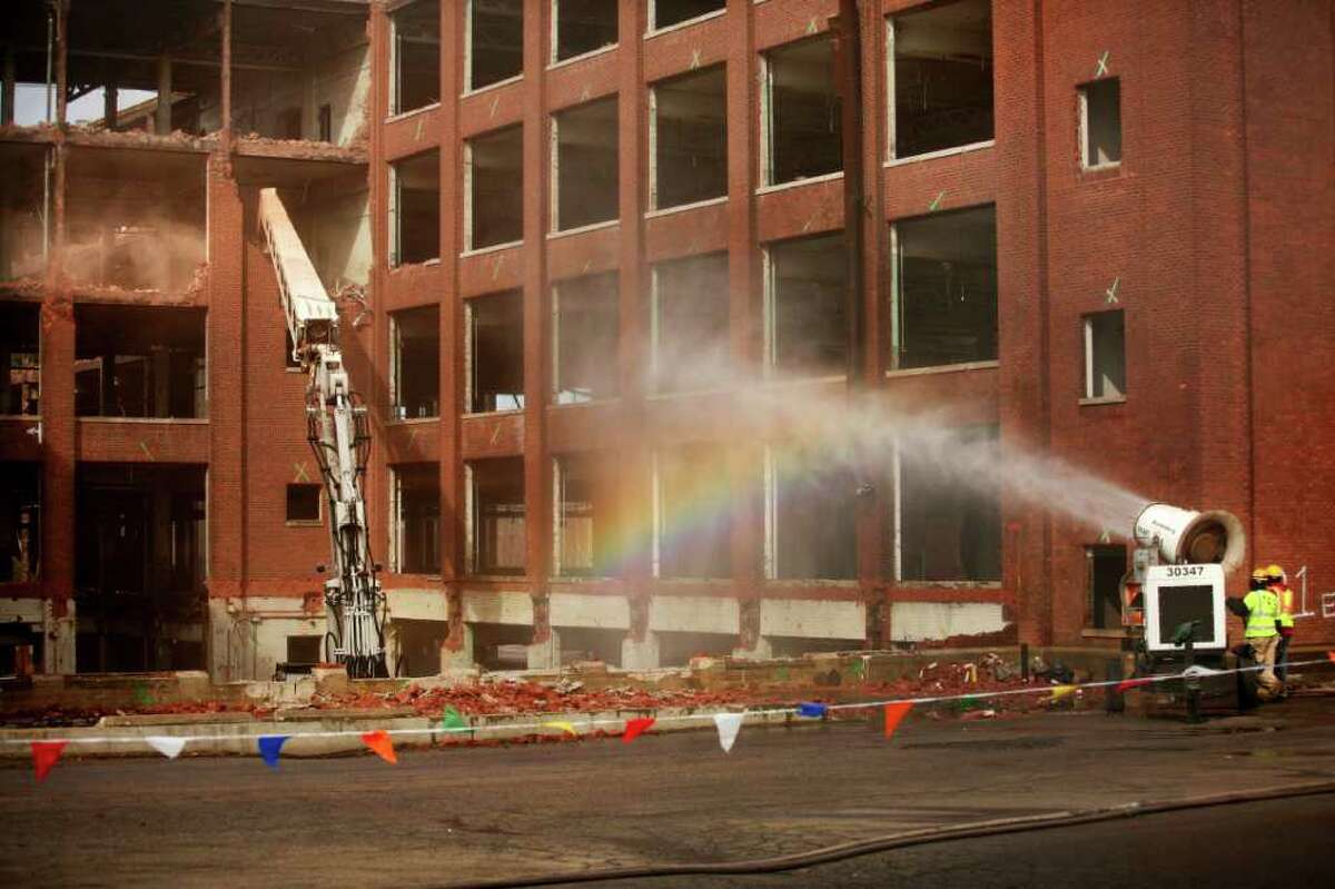 A rainbow hangs in the mist of a snowmaking machine, converted for use as dust control, as deconstruction continues on the General Electric factory on Boston Avenue in Bridgeport on Wednesday, February 22, 2012.