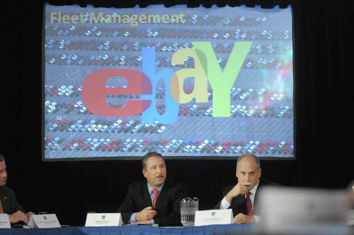 Howard Glaser, left, director of State Operations shows a presentation on the plan to sell agency vehicles on ebay during a cabinet meeting at the capitol on Wednesday, Feb. 22, 2012 in Albany, NY. Also pictured is Larry Schwartz, secretary to the Governor. (Paul Buckowski / Times Union)