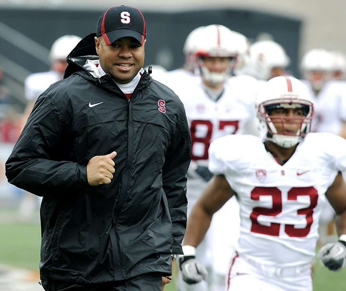 Stanford's head coach David Shaw, center, runs onto the field with his team before the first half of an NCAA football game against Oregon State in Corvallis, Ore., Saturday, Nov. 5, 2011.