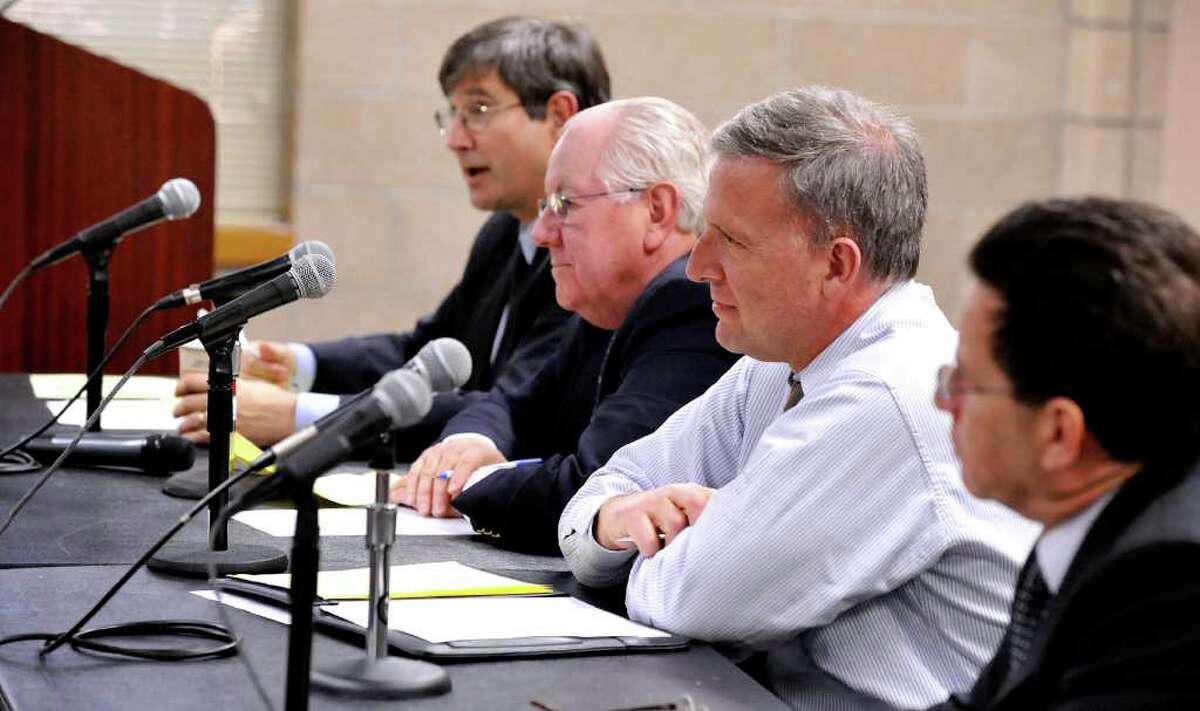 Some members of the White Street Task Force, including from left, Paul Reis, Wayne Shepperd, Steve Rosentel and Paul Steinmetz, listen to a speaker blaming the third lane for increasing the danger for pedestrians crossing White Street in Danbury. The public hearing was held at the Western Connecticut State University's midtown campus Thursday, Feb. 23, 2012.