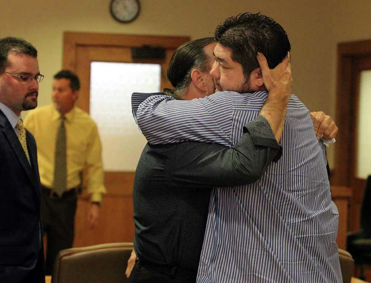 Noah Yuchnitz (right) hugs his dad, Mike Yuchnitz, at the conclusion of the father’s divorce trial with Tina Yuchnitz.