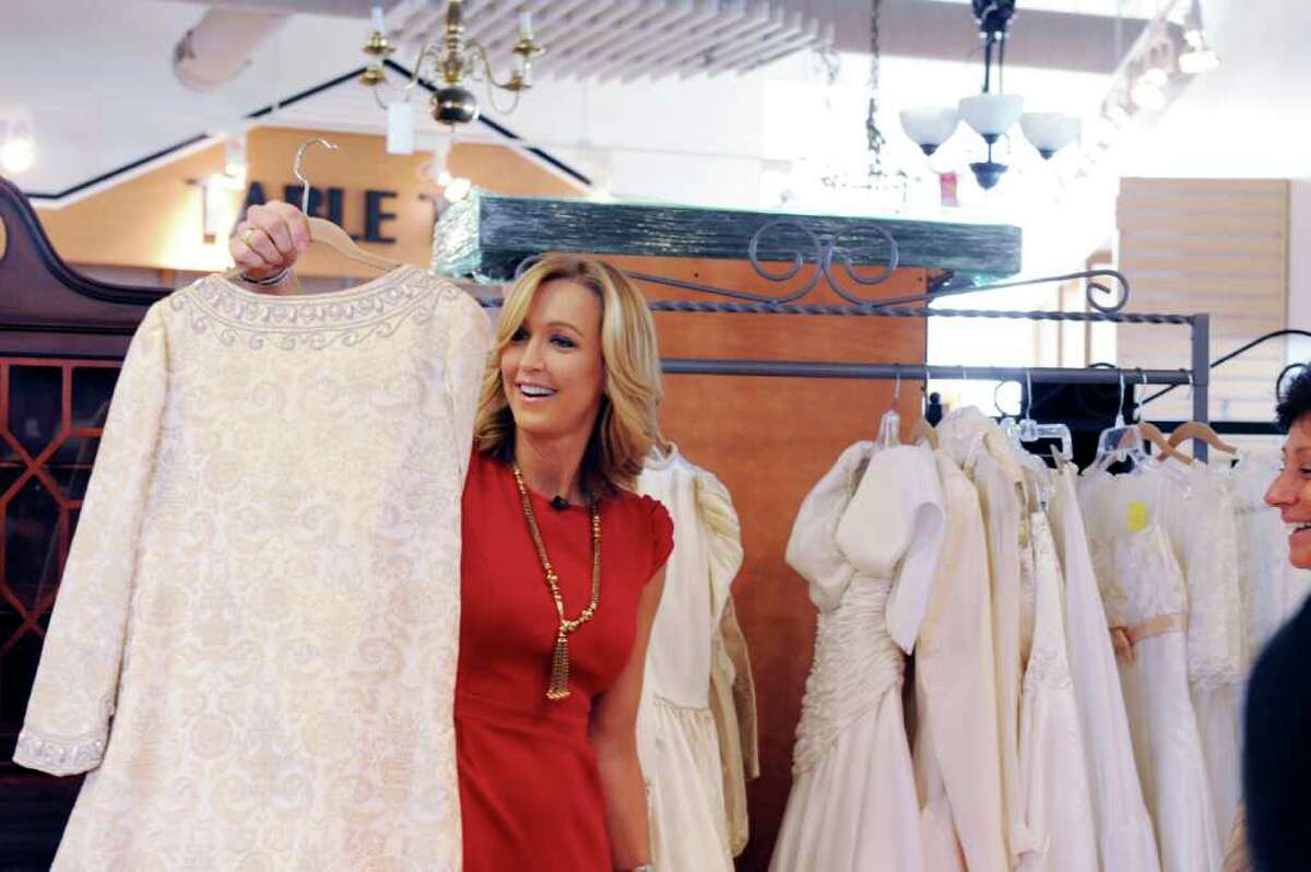 Greenwich resident Lara Spencer, the lifestyle anchor for "Good Morning America," looks at wedding gowns at the Greenwich Hospital Auxiliary Thrift Shop Thursday, Feb. 23, 2012 for a segment for a featuring on thrift stores. The shop is showcasing its selection of designer wedding gowns and tuxedos.
