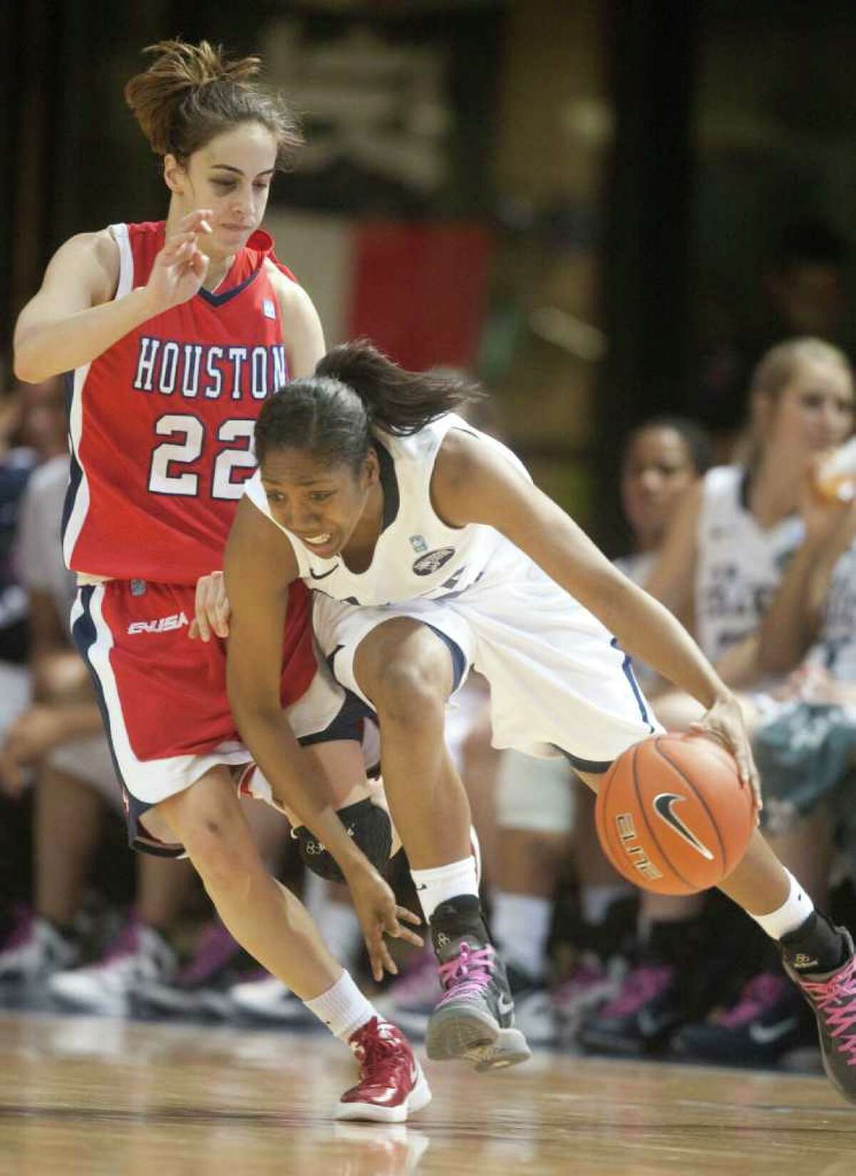 Rice guard Maya Adetula (22) drives against University of Houston guard Roxana Button (22) during the second half of a NCAA college basketball game at Tudor Field House on Thursday, February 23, 2012 in Houston, TX. The Owls defeated the Cougars 68-40.
