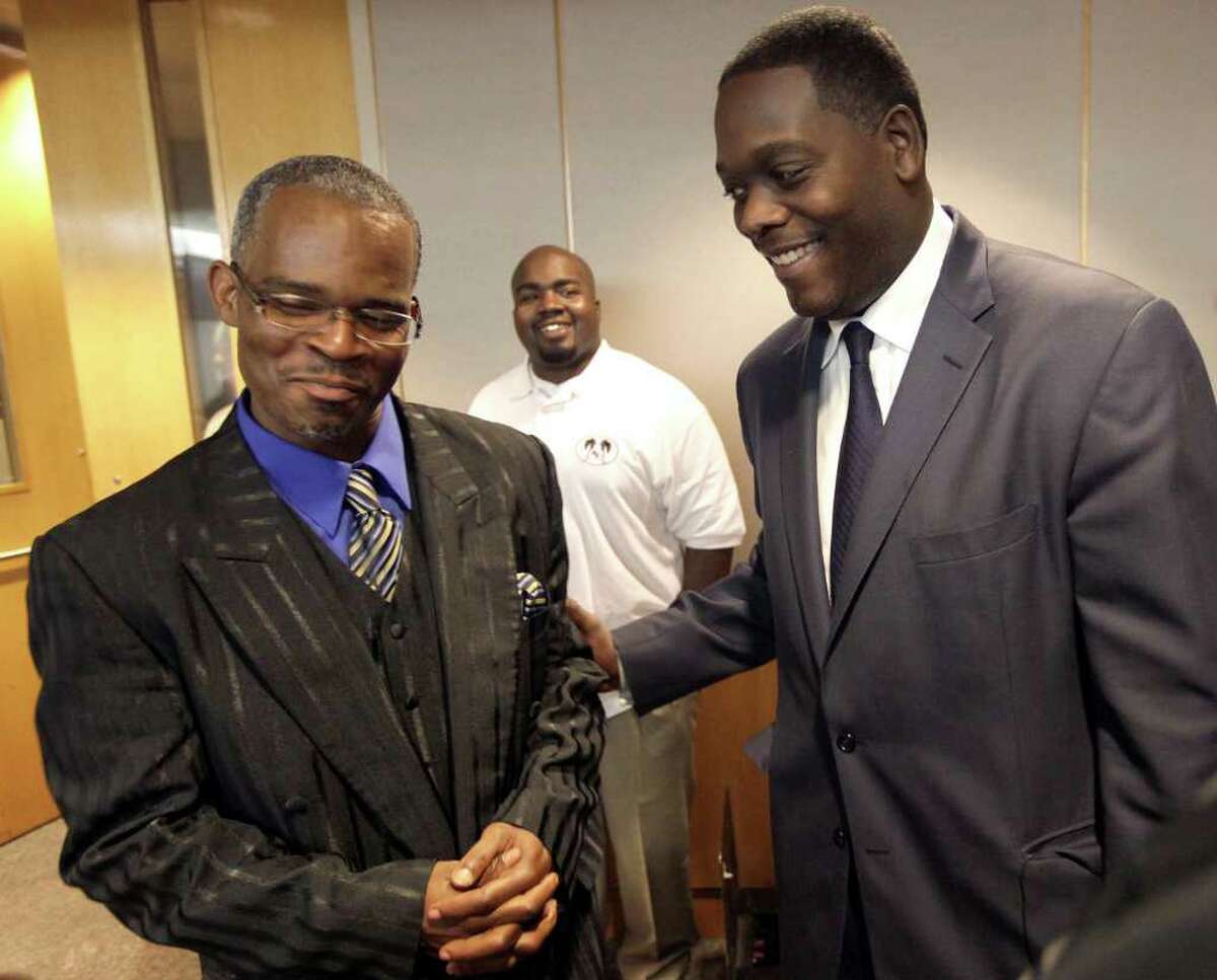 District Attorney Craig Watkins, right, greets Richard Miles at state district court in Dallas, Wednesday, Feb. 22, 2012. State District Judge Andy Chatham read read the Texas Court of Criminal Appeals ruling of "actual innocence" for Miles who was wrongfully convicted of murder and attempted murder for which he spent 14 years in prison. (AP Photo/LM Otero)