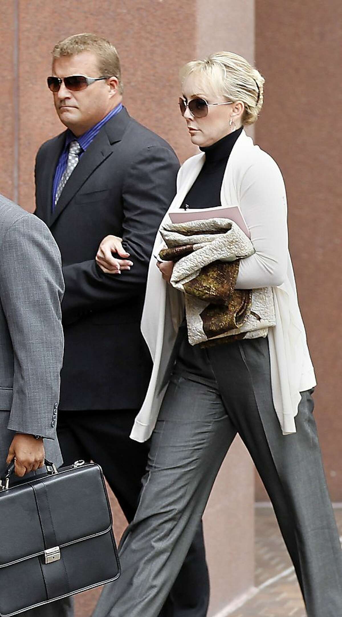 Defendant Theresa Erickson, right, and her husband John Erickson, arrive at Federal Court in downtown San Diego, Friday Feb. 24, 2012. Erickson, 44, a California lawyer who was a respected reproductive law specialist was sentenced Friday to five months in prison and nine months of home confinement for her role in what prosecutors say was a baby-selling scheme. U.S. District Court Judge Anthony Bataglia also ordered Theresa Erickson, 44, to pay a $70,000 fine. Co-defendant Carla Chambers was sentenced to five months in prison and seven months in home confinement. Both women had faced up to five years in prison. (AP Photo/U-T San Diego, ) SAN DIEGO COUNTY OUT; NO SALES; COMMERCIAL INTERNET OUT; FOREIGN OUT