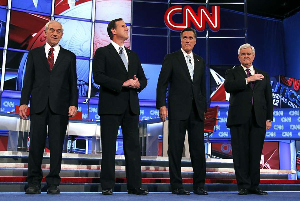 Republican presidential candidates, from left, Rep. Ron Paul, R-Texas, former Pennsylvania Sen. Rick Santorum, former Massachusetts Gov. Mitt Romney and former House Speaker Newt Gingrich stand together after being introduced during a Republican presidential debate among the 2012 candidates Wednesday, Feb. 22, 2012, in Mesa, Ariz.(AP Photo/Ross D. Franklin)