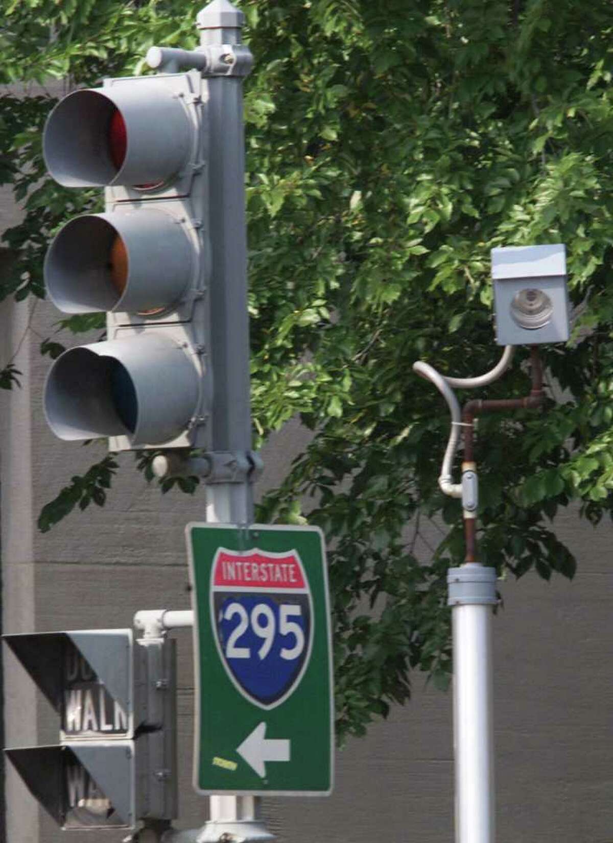 A camera is placed near a traffic light for drivers who run red lights on Constitution Avenue August 31, 2001 in Washington, DC. Connecticut legislators are considering enabling municipalities to use the cameras, but there is conflicting evidence on whether they actually improve safety. (Photo by Mark Wilson/Getty Images)
