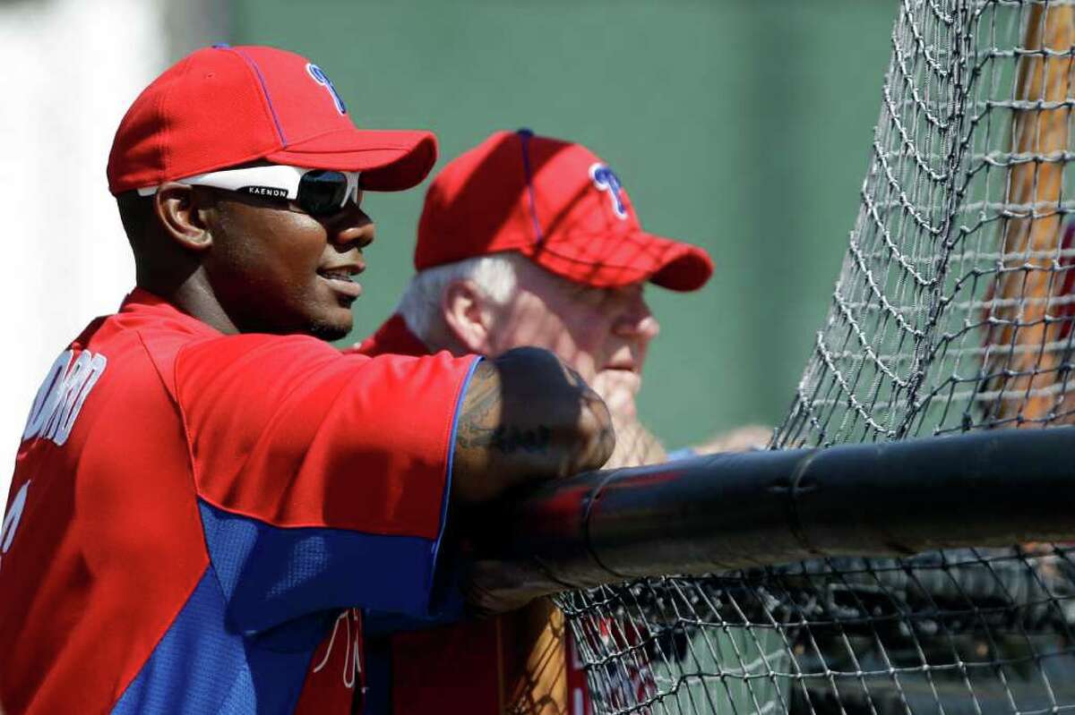 Philadelphia Phillies' Ryan Howard, left, and manager Charlie Manuel watch batting practice during practice at baseball spring training, Friday, Feb. 24, 2012, in Clearwater, Fla.