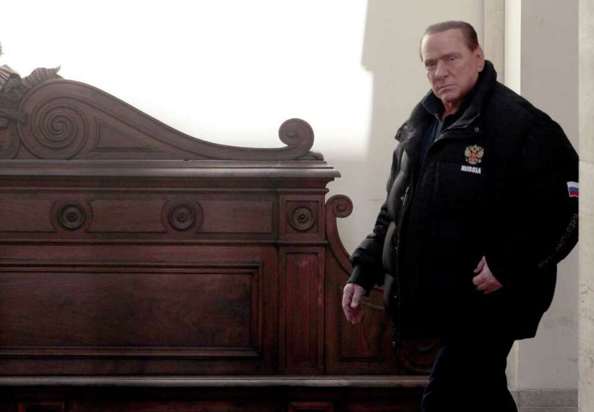 Former Italian Premier Silvio Berlusconi leaves his residence of Palazzo Grazioli in Rome, Saturday, Feb. 25, 2012. Defense lawyers for Silvio Berlusconi are making their final arguments in the former premier's corruption trial before the court begins deliberations. A verdict in the case is expected later Saturday but is unlikely to have any lasting legal force due to statute of limitations. Berlusconi is accused of having paid a British lawyer $600,000 to lie in two 1990s trials related to the billionaire media mogul's business dealings. (AP Photo/Gregorio Borgia)