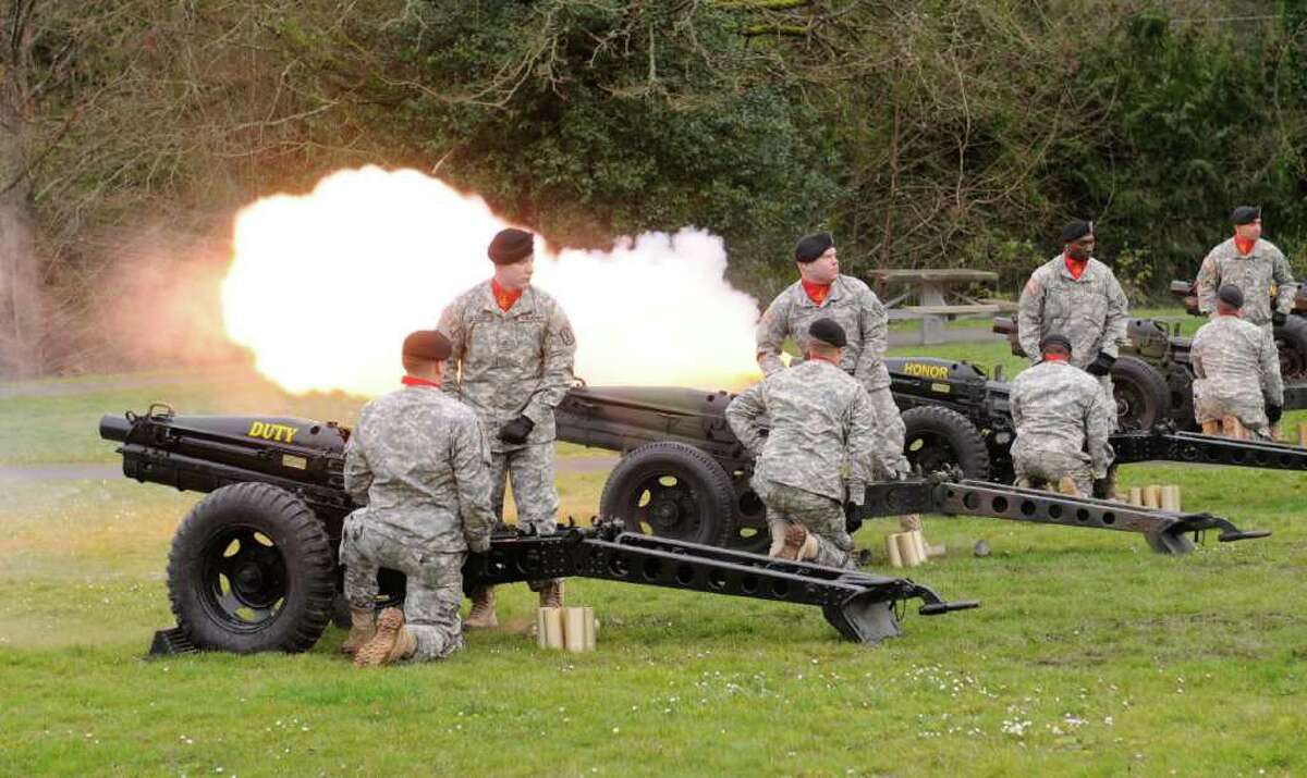 Members of the U.S. Army's 364th Sustainment Command fire cannons during the Ft. Lawton Post Closure Ceremony outside the Daybreak Star Indian Cultural Center in Seattle on Saturday, Feb. 25, 2012. Ft. Lawton was the second-largest deployment site on the West Coast during WWII, and was a major processing center during the Korean War.
