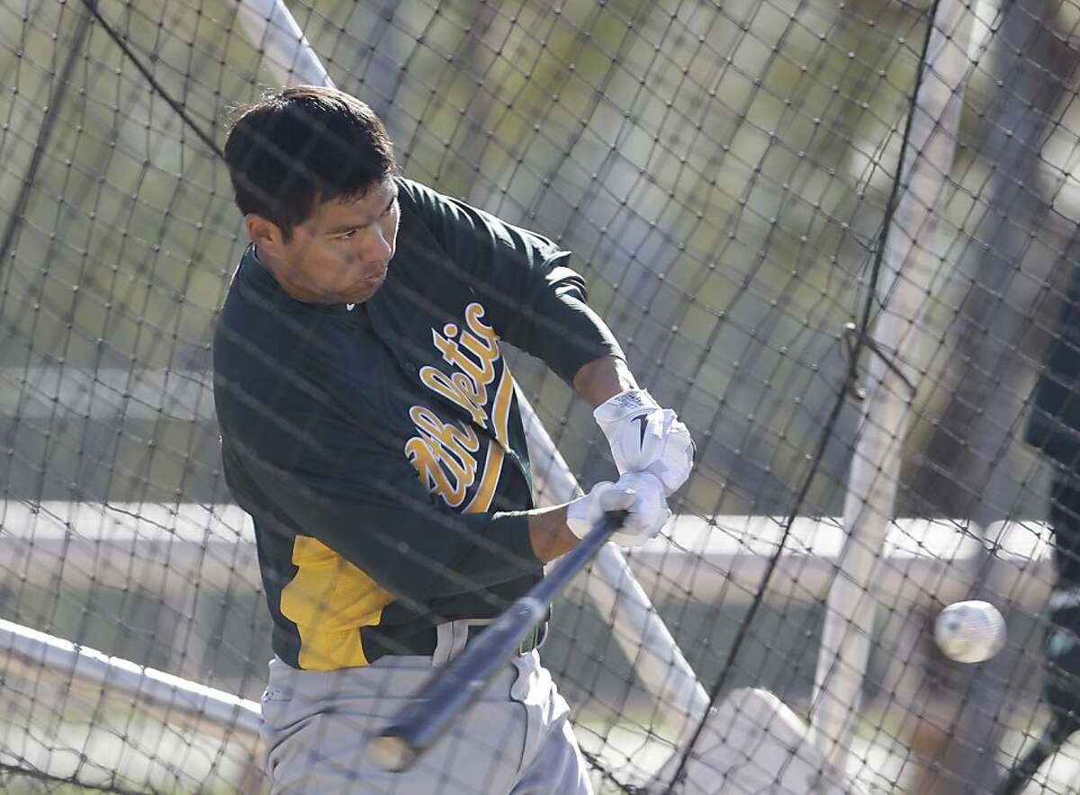 Oakland Athletics' Kurt Suzuki during a spring training baseball workout Tuesday, Feb. 21, 2012, in Phoenix. (AP Photo/Darron Cummings)