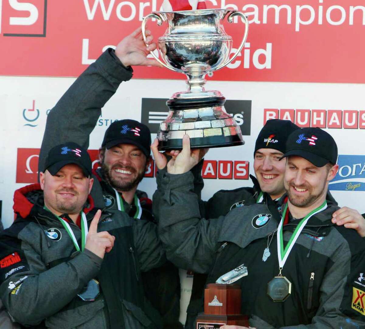 United States' men's four-man bobsled team holds the Martineau Cup after winning the bobsled world championships in Lake Placid, N.Y., on Sunday, Feb. 26, 2012. From left to right, are: Steven Holcomb, Steven Langton, Justin Olsen and Curtis Tomasevicz.