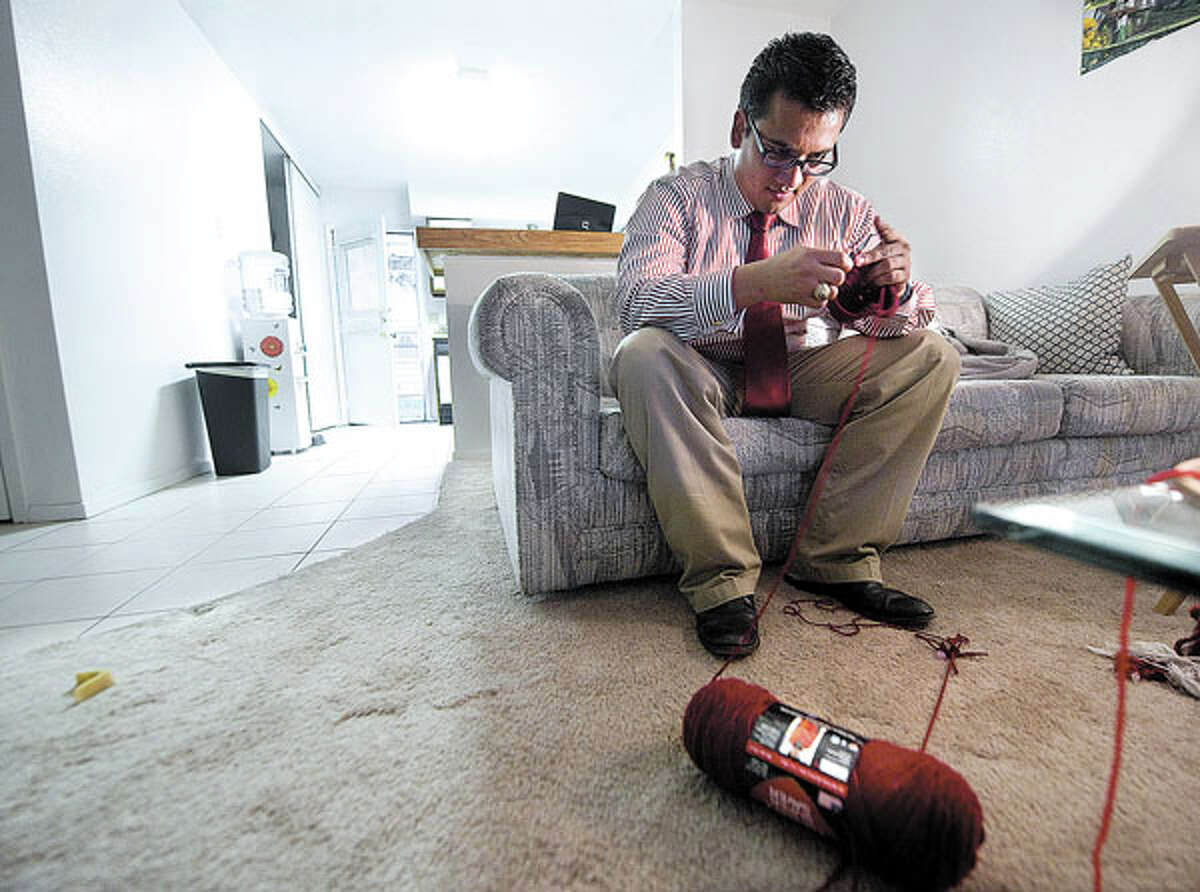 Texas A&M graduate student Jose Lius Zelaya crochets at his apartment Wednesday, Feb. 22, 2012. Zelaya crochets beanies t help pay for his schooling. He is running for student body president at the university. (eagle photo/ stuart villanueva)
