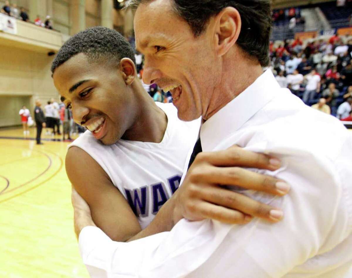 Warren’s Marcus Keene (left) and coach Jim Weaver celebrate beating Judson 64-61 in overtime on Keene’s 3-pointer at the buzzer on Monday night.