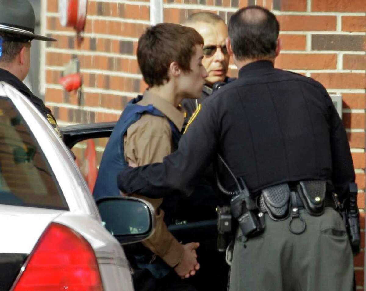T.J. Lane, a suspect in Monday's shooting of five students at Chardon High School is taken into juvenile court by Geauga County deputies in Chardon, Ohio Tuesday, Feb. 28, 2012. Three of the five students wounded in the attacks have since died.