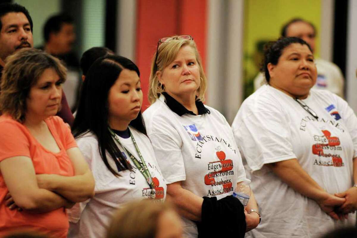 Supporter of the Edgewood Classroom Teachers Association stand in support of topics being presented to board members during an Edgewood School Board meeting at Roy Cisneros Elementary School in San Antonio.