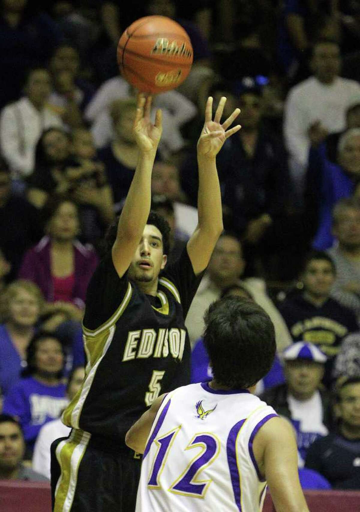 Edison's Arty Vela (05) hoists a three-pointer over Brackenridge's Anthony Garza (12) in the third round of District 29-4A basketball at the Alamo Convocation Center on Tuesday, Feb. 28, 2012. Edison defeated Brackenridge, 64-53.
