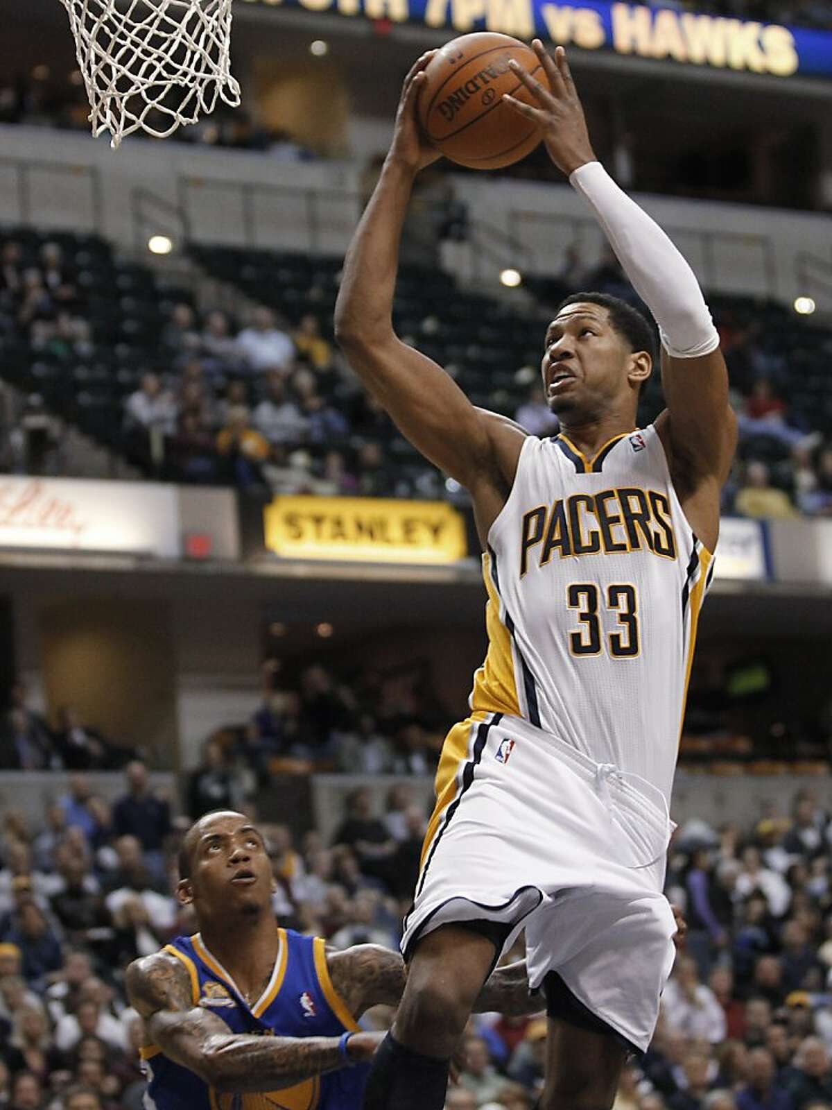 Indiana Pacers forward Danny Granger (33) goes to the basket over Golden State Warriors' Monta Ellis, left, during the third quarter of an NBA basketball game in Indianapolis on Tuesday, Feb. 28, 2012. Granger scored 25 points in the Pacers' 102-78 win. (AP Photo/Dave Martin)