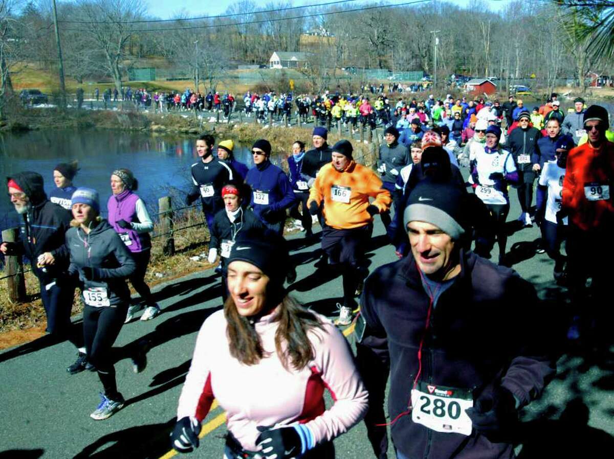 SPECTRUM/Stacie and Matt Perachi of Washington momentarily move front and center as they begin their tour of the lake during the 28th edition of the 7.66-mile Polar Bear Run around Lake Waramaug. Feb. 26, 2012