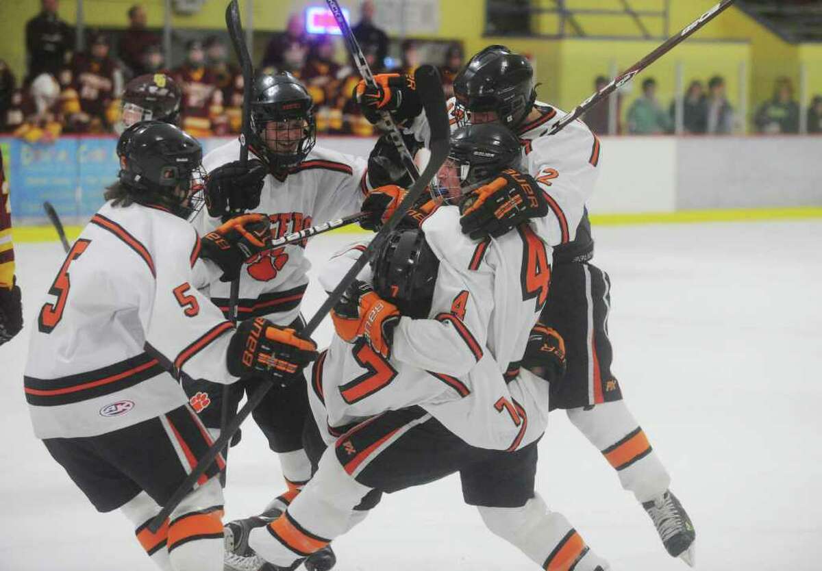 The Ridgefield Tigers pile onto Christopher Morrow, jersey number 7, after his first period goal as St. Joseph and Ridgefield High Schools face off in the FCIAC boys hockey semifinals at Terry Conners Rink in Stamford, Conn., February 29, 2012.