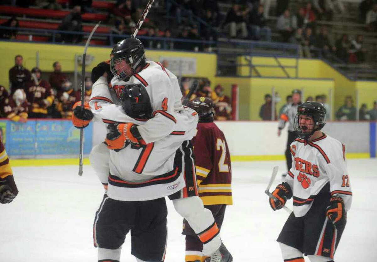 Ridgefield's Christopher Morrow, jersey number 7, celebrates a goal with teammate Daniel McMullen as St. Joseph and Ridgefield High Schools face off in the FCIAC boys hockey semifinals at Terry Conners Rink in Stamford, Conn., February 29, 2012.
