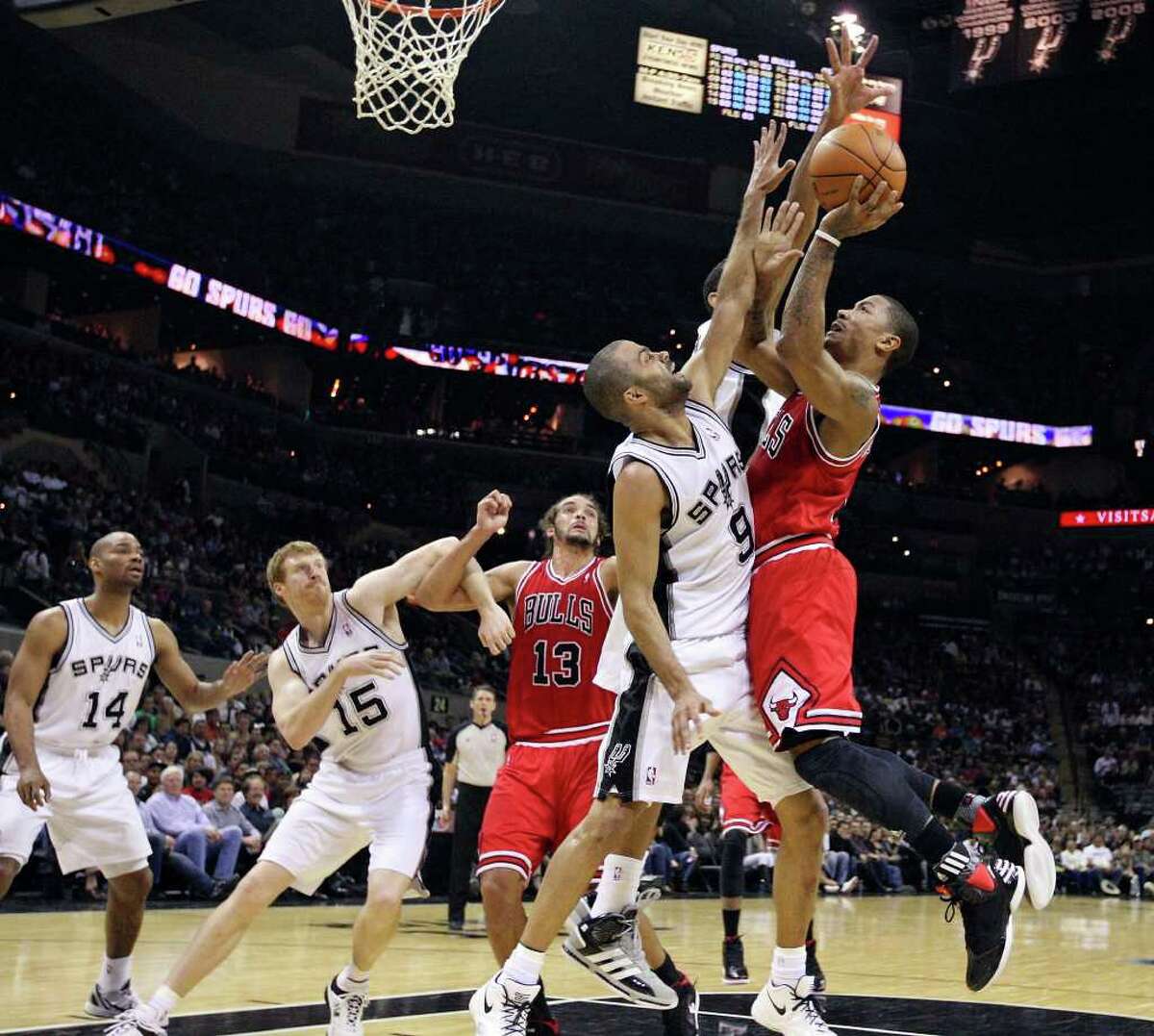 Chicago Bulls' Derrick Rose shoots over San Antonio Spurs' Tony Parker during first half action Wednesday Feb. 29, 2012 at the AT&T Center.