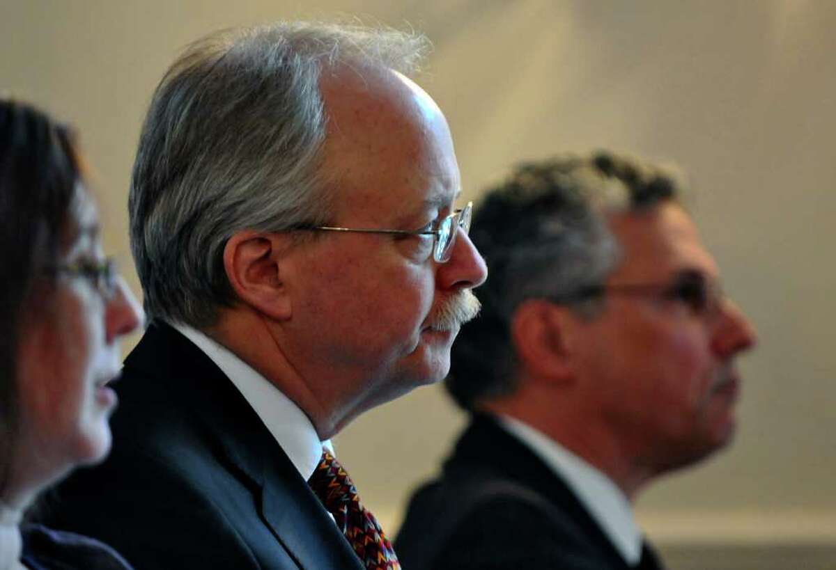 Thomas Gais, Director of the Nelson A. Rockefeller Institute of Government, right, and Robert Ward, Deputy Director of the institute, center, listen to City of Rochester Mayor Thomas Richards speak during a public policy forum titled "Local Fiscal Challenges and New York's Tax Cap," at the institute on Thursday afternoon March 1, 2012 in Albany, N.Y. (Philip Kamrass / Times Union )