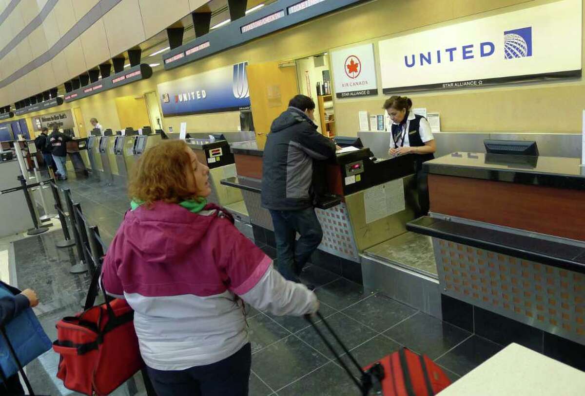 Signage at the former Continental check-in counter has already been changed to United at the Albany International Airport in Colonie , N.Y. Thursday March 1, 2012.( Michael P. Farrell/Times Union)