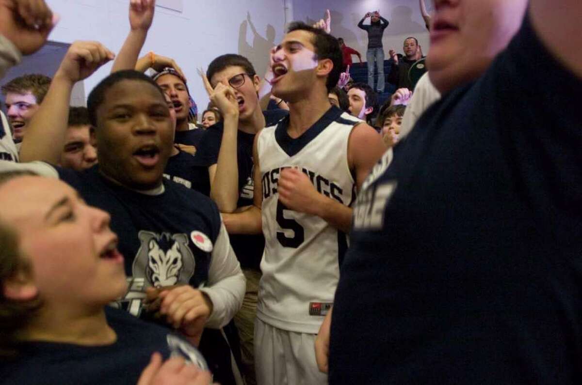 Immaculate's Marcos DeOliveira celebrates with the fans after their 64-53 SWC championship win against Notre Dame Fairfield at Weston High School on Thursday, March 1, 2012.