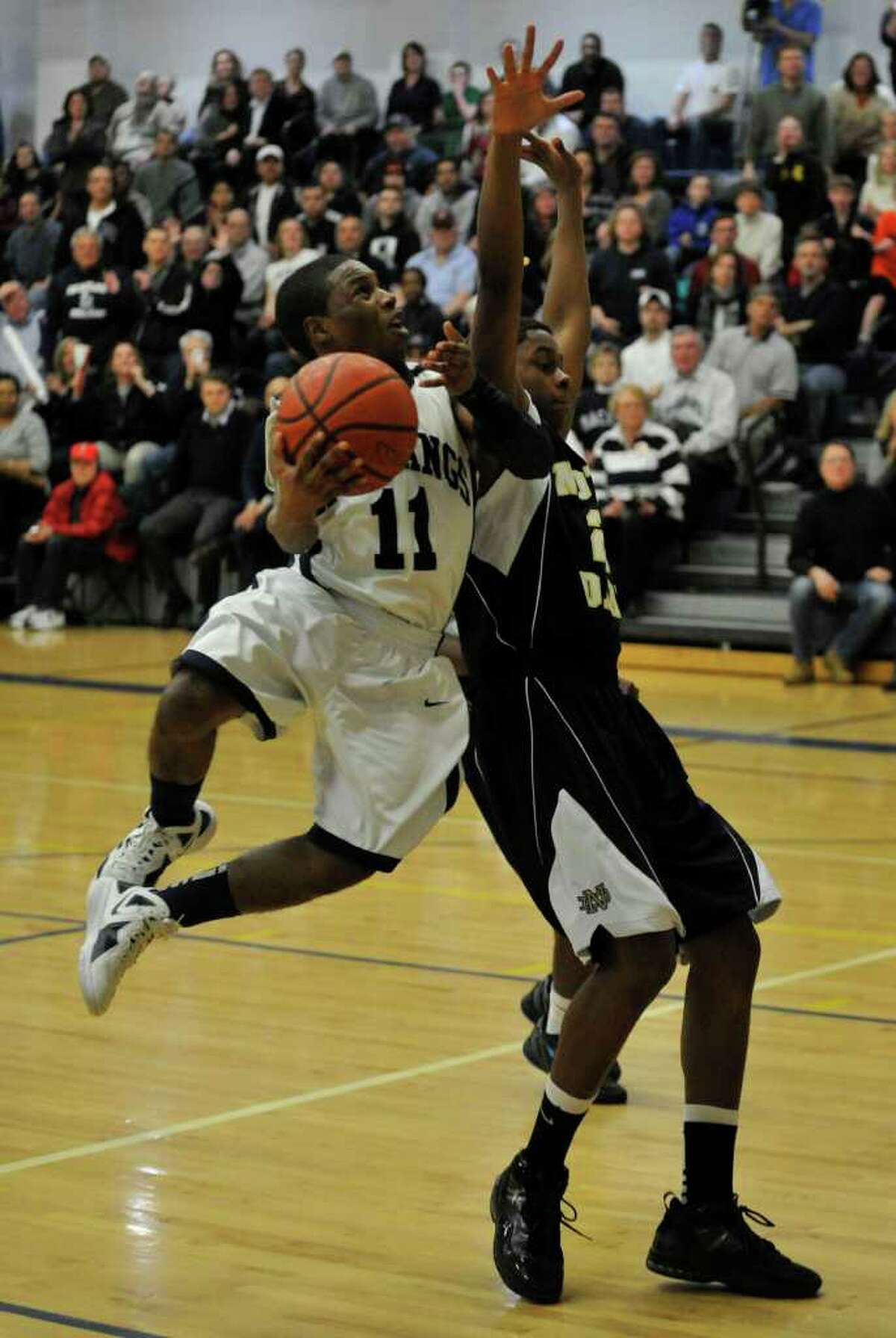 Immaculate's Daniel McCorkle shoots while under pressure from Notre Dame Fairfield's Jaylen Jennings during their SWC championship game at Weston High School on Thursday, March 1, 2012. Immaculate won 64-53.
