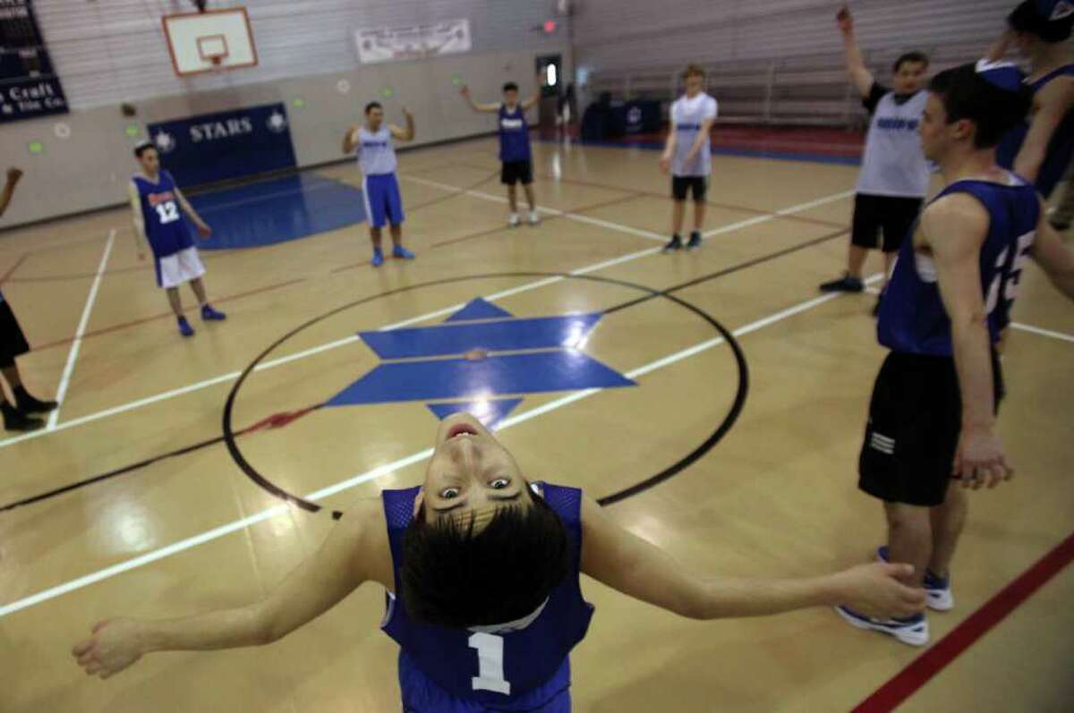 Albert Katz, 16, and fellow basketball players stretches out during their last basketball practice at Beren Academy on Thursday, March 1, 2012, in Houston. TAPPS is allowing Beren Academy Boys Basketball team to participate in the 2A state semifinals over the weekend.