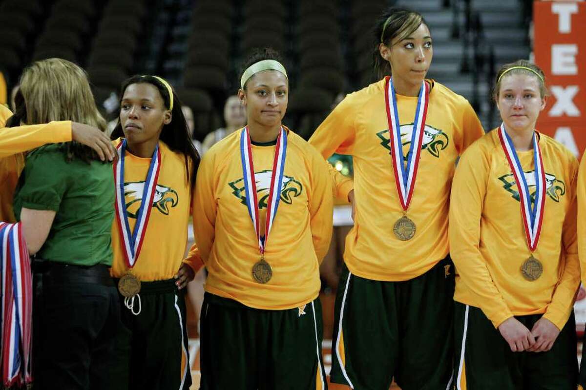 3/2/12 - Houston Cypress Falls' Loryn Goodwin (32), second from left, and teammates get their 3rd place medals after losing to Duncanville during the 5A Girls UIL state basketball semifinals in Austin, Texas March 2, 2012. (Erich Schlegel/Special Contributor)
