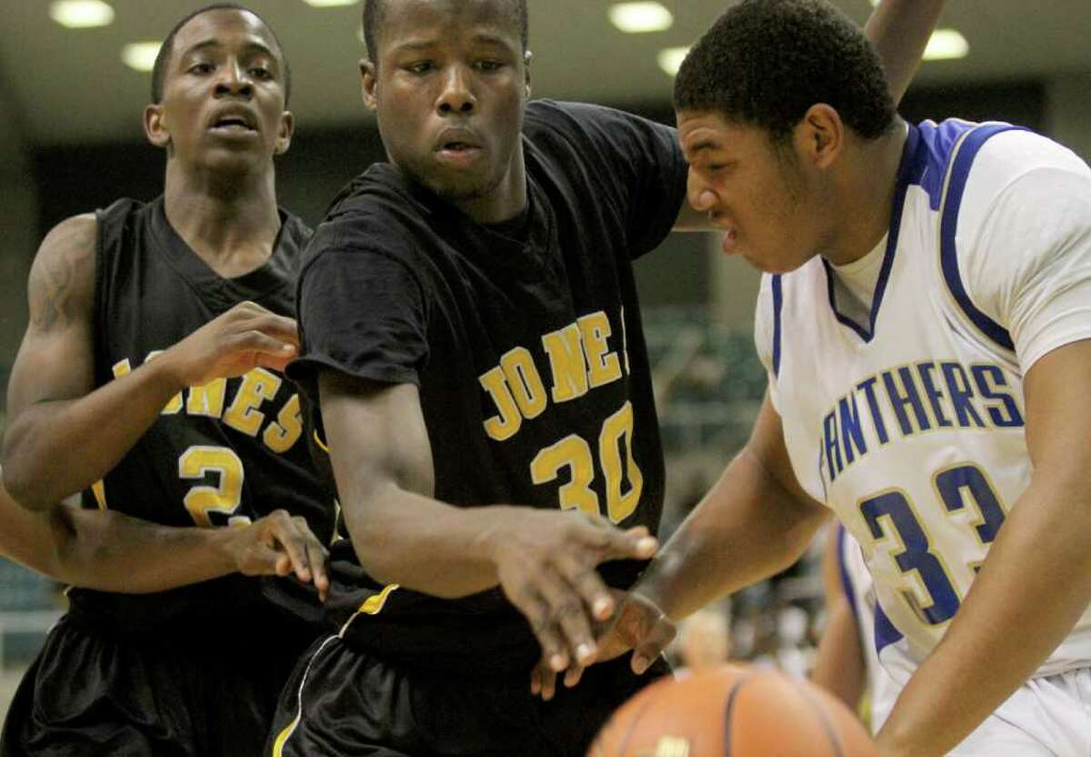3/2/2012: Patrick Smith #2 and Broderick Harris #30 of Jones fights for a rebound against terry Vaughn #33 of Ozen in the 4A regional semifinals high school mens basketball game at the Merrell Center in Katy, Texas.