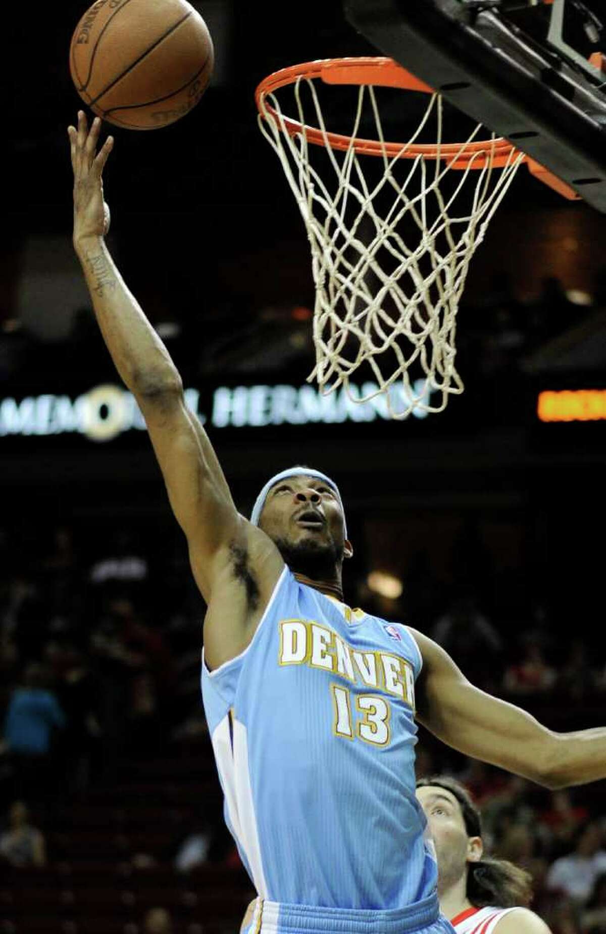 Denver Nuggets' Corey Brewer (13) lays in a shot for two points in the first half of an NBA basketball game against the Houston Rockets Friday,, March 2, 2012, in Houston. (AP Photo/Pat Sullivan)