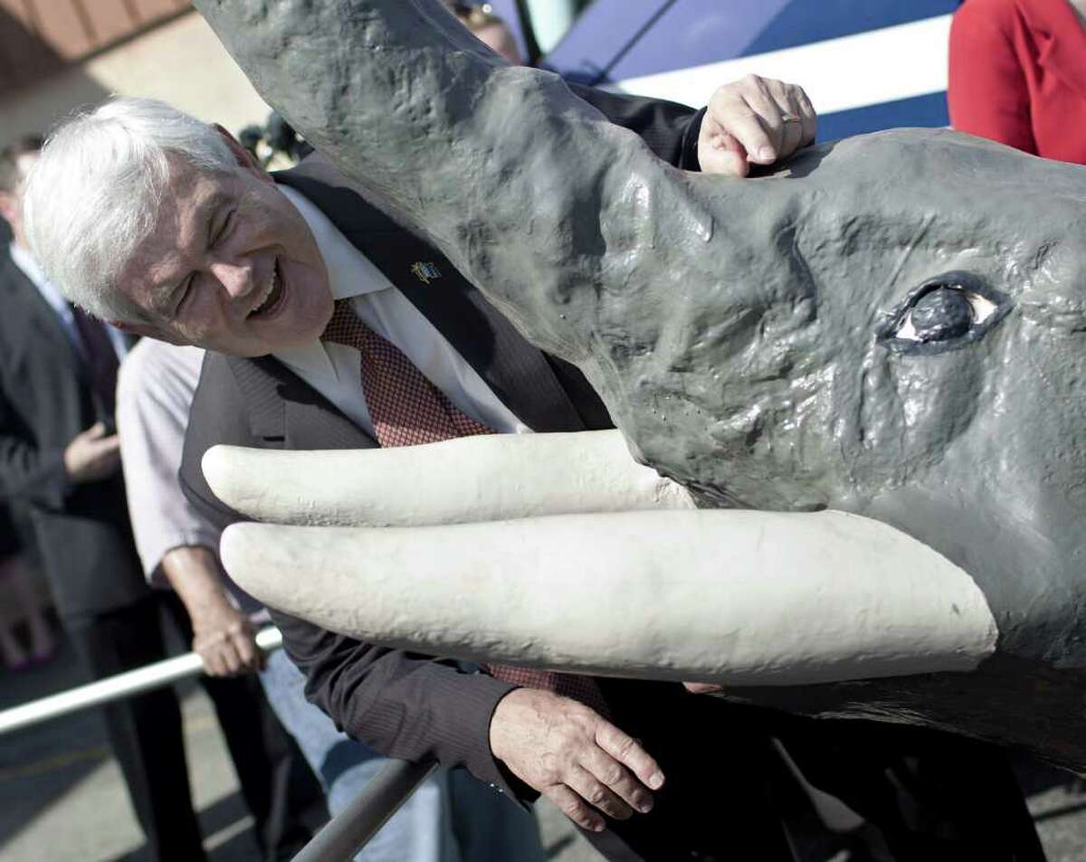 US Presidential hopeful poses with the symbol of the Republican Party, an elephant, after a rally March 2, 2012 in Savannah, Georgia. US Presidential nominee hopeful and former Speaker of the US House of Represenatives Newt Gingrich is campaigning throughout Georgia in preparation for Super Tuesday when the greatest number of states hold primary elections with 437 delegates at stake, including the Georgia's 76.