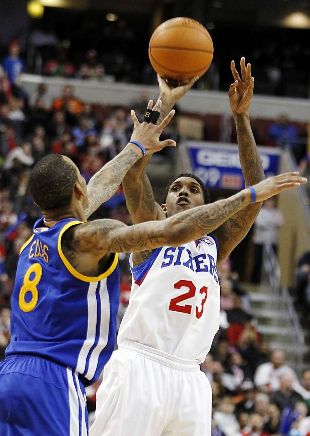 Golden State Warriors guard Monta Ellis (8) defends as Philadelphia 76ers guard Lou Williams (23) shoots in the second half of an NBA basketball game, Friday, March 2, 2012, in Philadelphia. Williams led all scorers with 25 points as the 76ers won 105-83. (AP Photo/Alex Brandon)