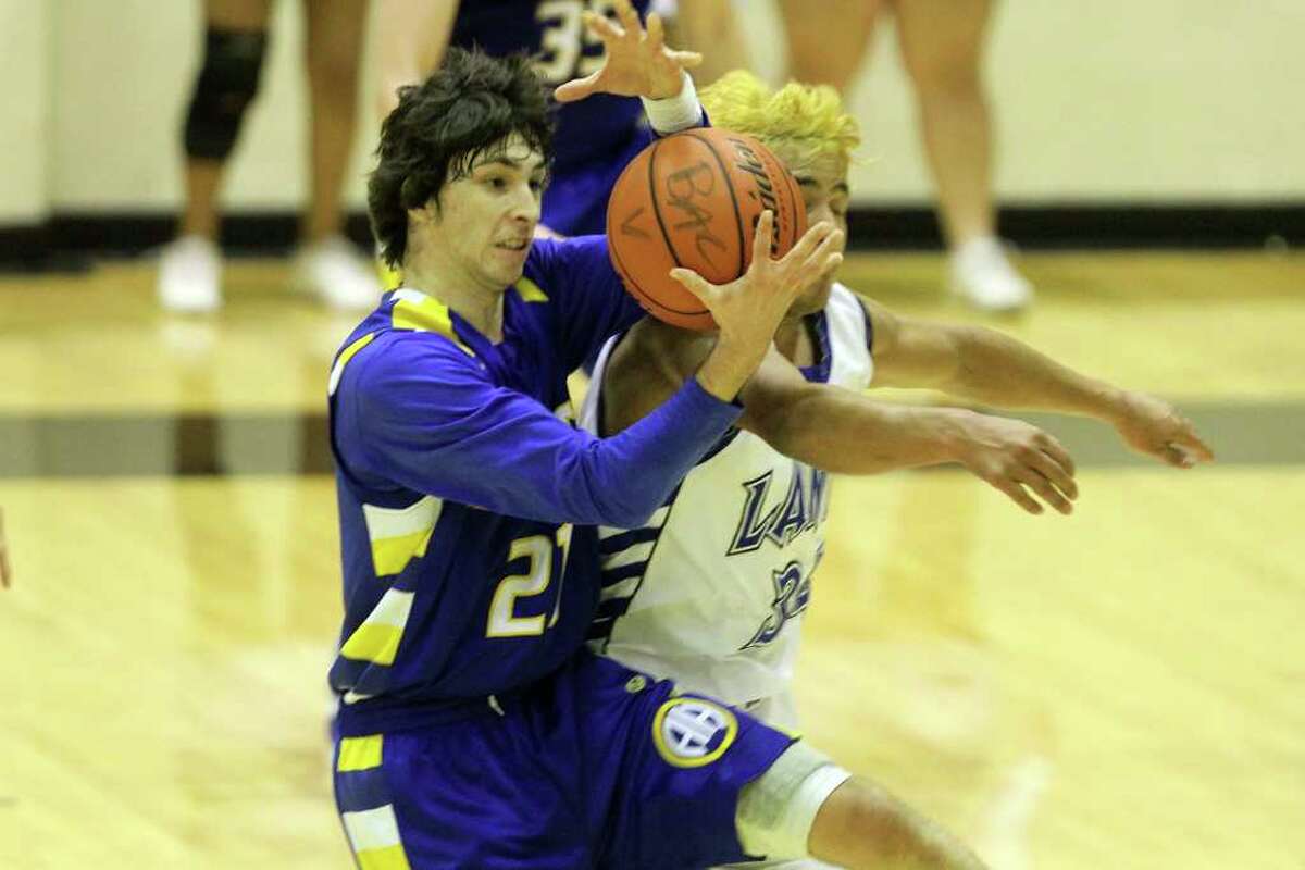 Alamo Heights' Dylan Lieck holds on to the rebound. Alamo Heights beat Lanier 72-58 in the Region IV-4A semifinals at Littleton Gymnasium, Friday, March 2, 2012. (JENNIFER WHITNEY)