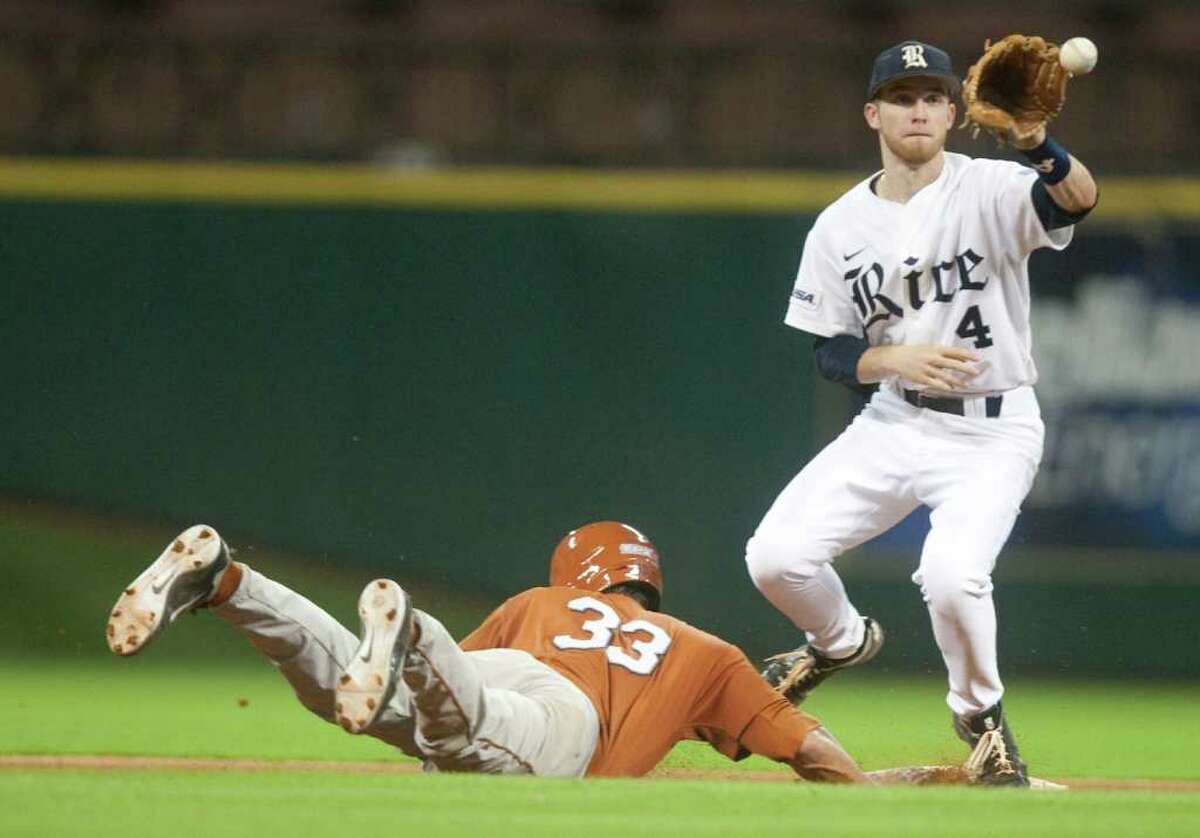 Rice's Derek Hamilton (4) attempts to pick off Texas' Jonathan Walsh (33) during the sixth inning of the Houston College Classic at Minute Maid Park on Friday.