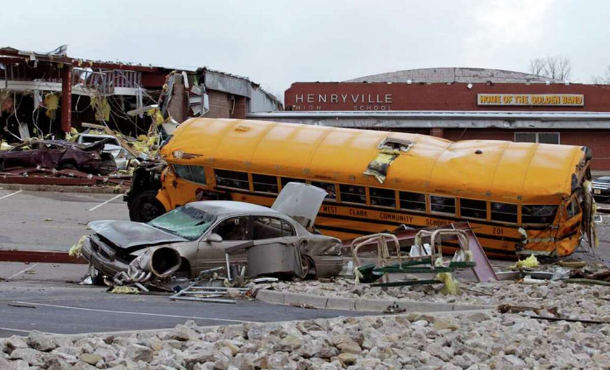 A vehicles damaged by a tornado lie in the parking lot of the Henryville Jr./Sr. High School in Henryville, Ind., Saturday, March 3, 2012. A string of violent storms demolished small towns in Indiana and cut off rural communities in Kentucky as an early season tornado outbreak killed more than 30 people, and the death toll rose as daylight broke on Saturday's search for survivors.