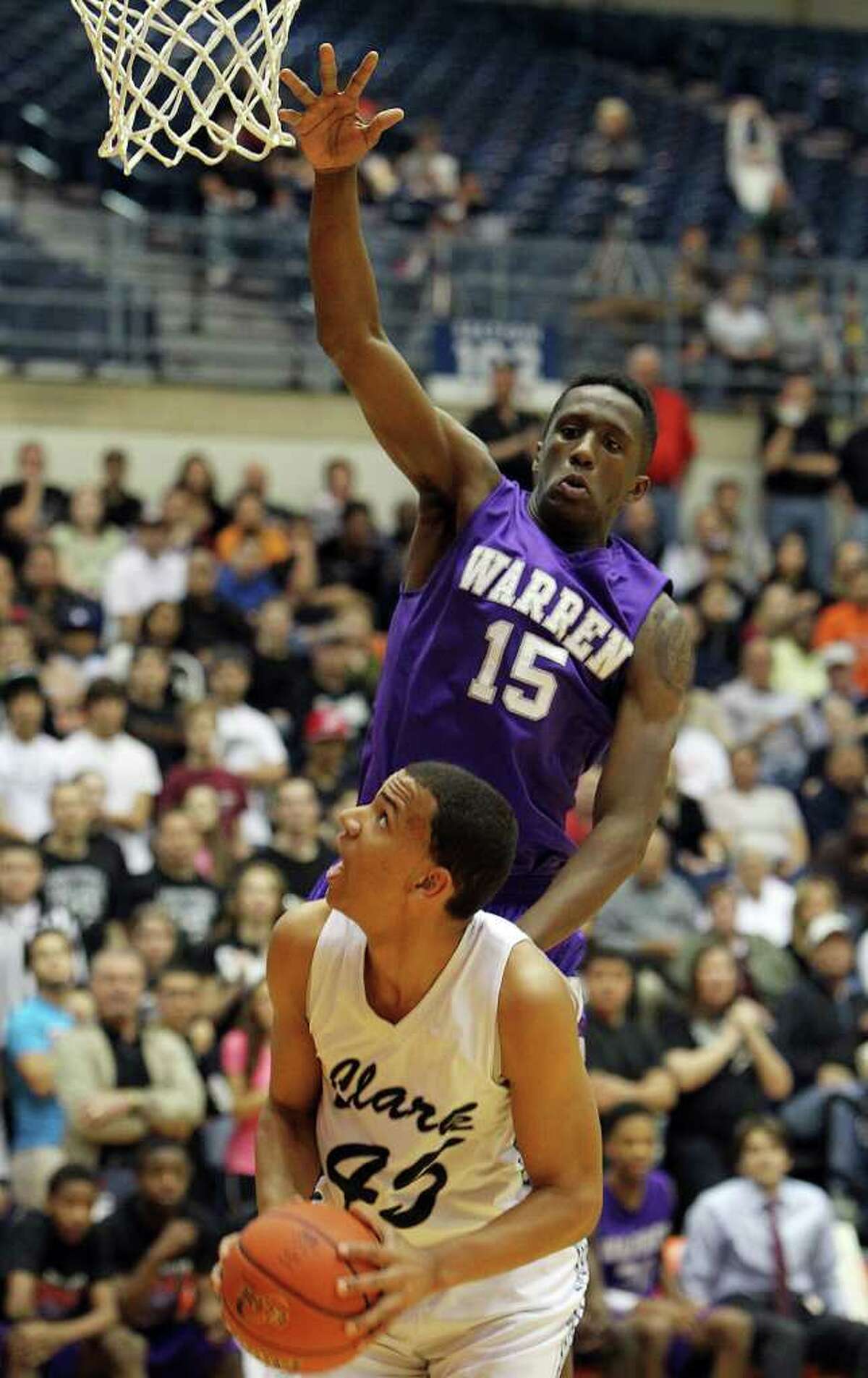 Warren's Taurean Waller-Prince (15) attempts a block on Clark's Shawn Gulley (45) in the Region IV-5A boys basketball finals at UTSA on Saturday, Mar. 3, 2012. Warren defeated Clark, 65-56, to earn a trip to the state tournament.