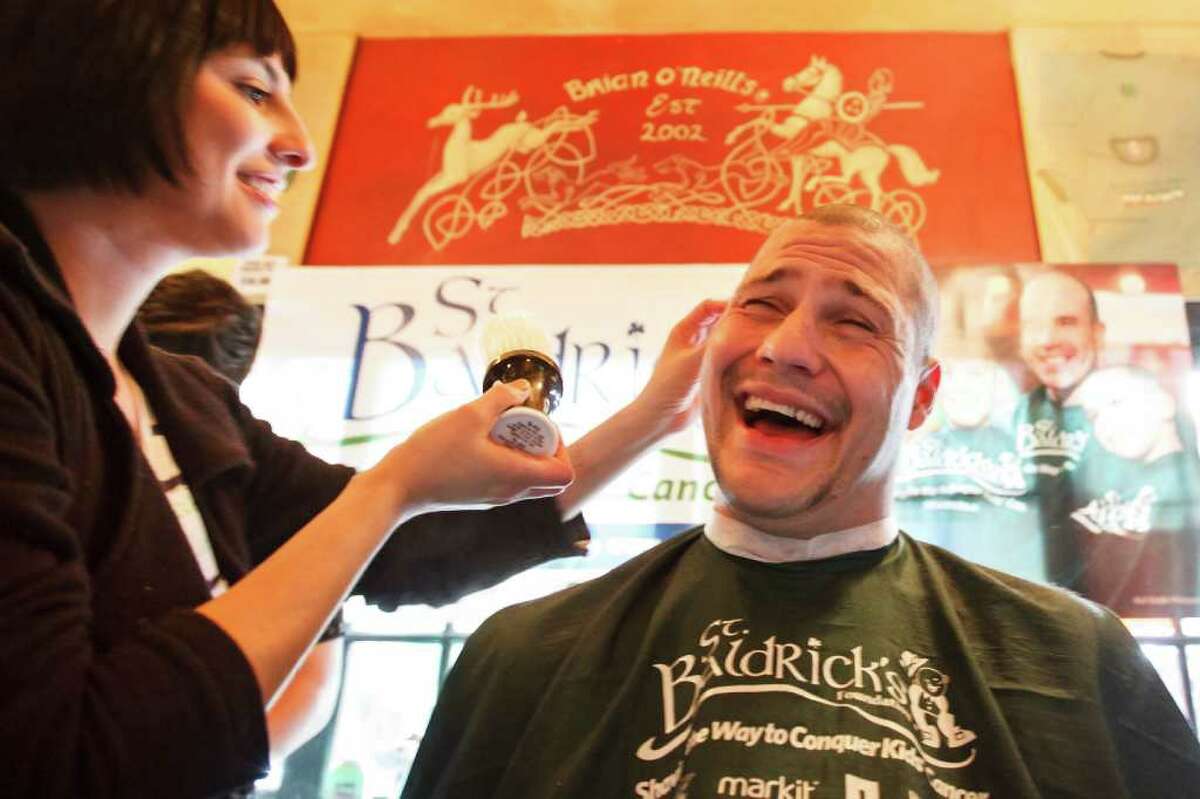 Greg Kopacz reacts as he has his head shaved by Rita Contreras during the St. Baldrick's Foundation Head-Shaving Event to raise funds for kids with cancer at Brian O'Neill's Irish Pub, Saturday, March 3, 2012, in Houston.