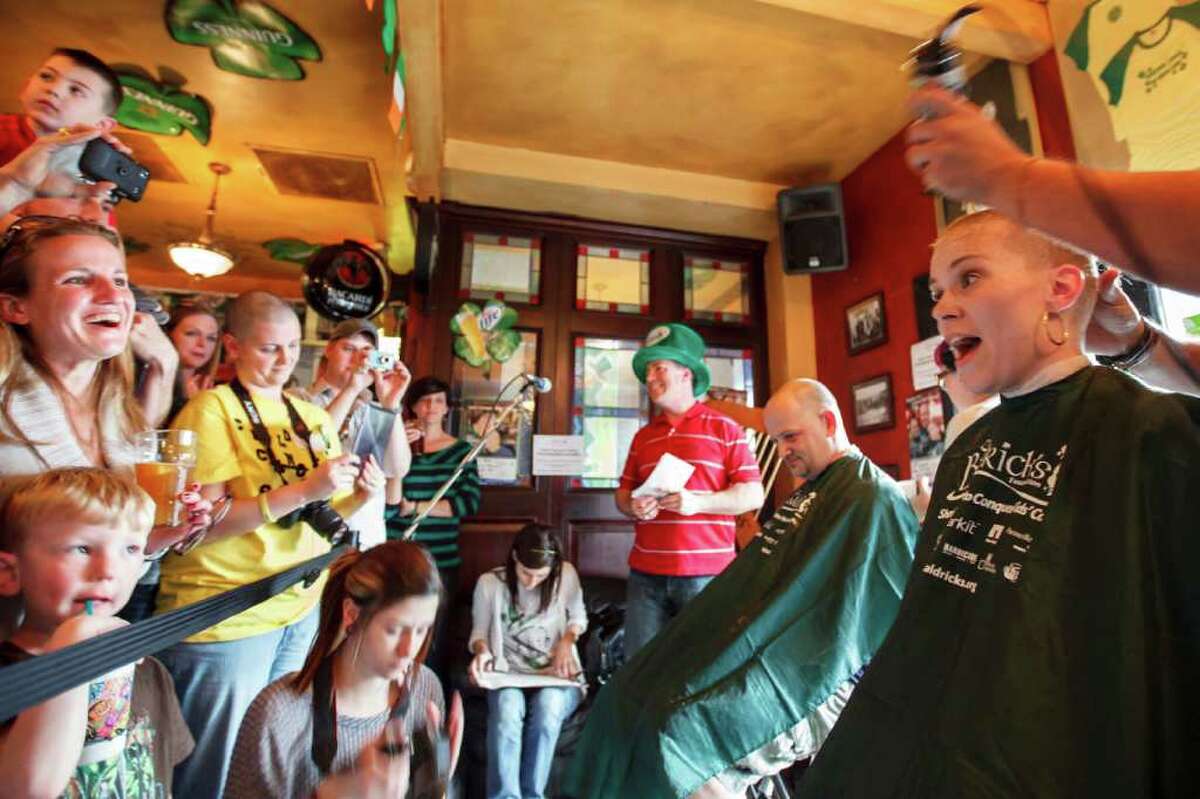 Wendi Schoffstall reacts as she gets her head shaved during the St. Baldrick's Foundation Head-Shaving Event to raise funds for kids with cancer at Brian O'Neill's Irish Pub, Saturday, March 3, 2012, in Houston. "It's just hair," Schoffstall said. "It will grow back."