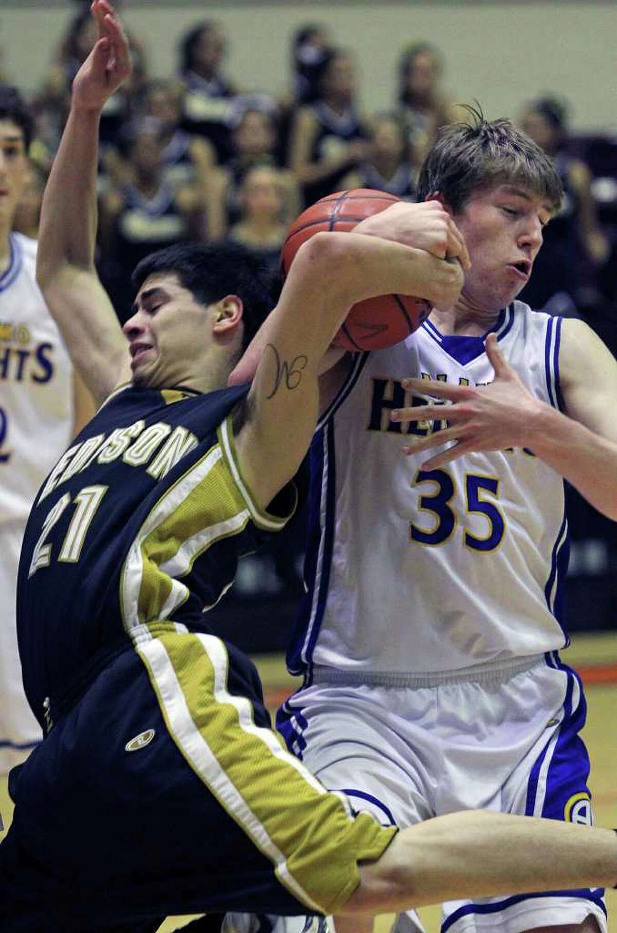 Marco Guerrero finds tough going in the lane in the second half as Wes Miller moves in to grab the ball as Alamo Heights beats Edison 50-39 in Region IV 4A finals at Littleton Gym on March 3, 2012 Tom Reel/ San Antonio Express-News